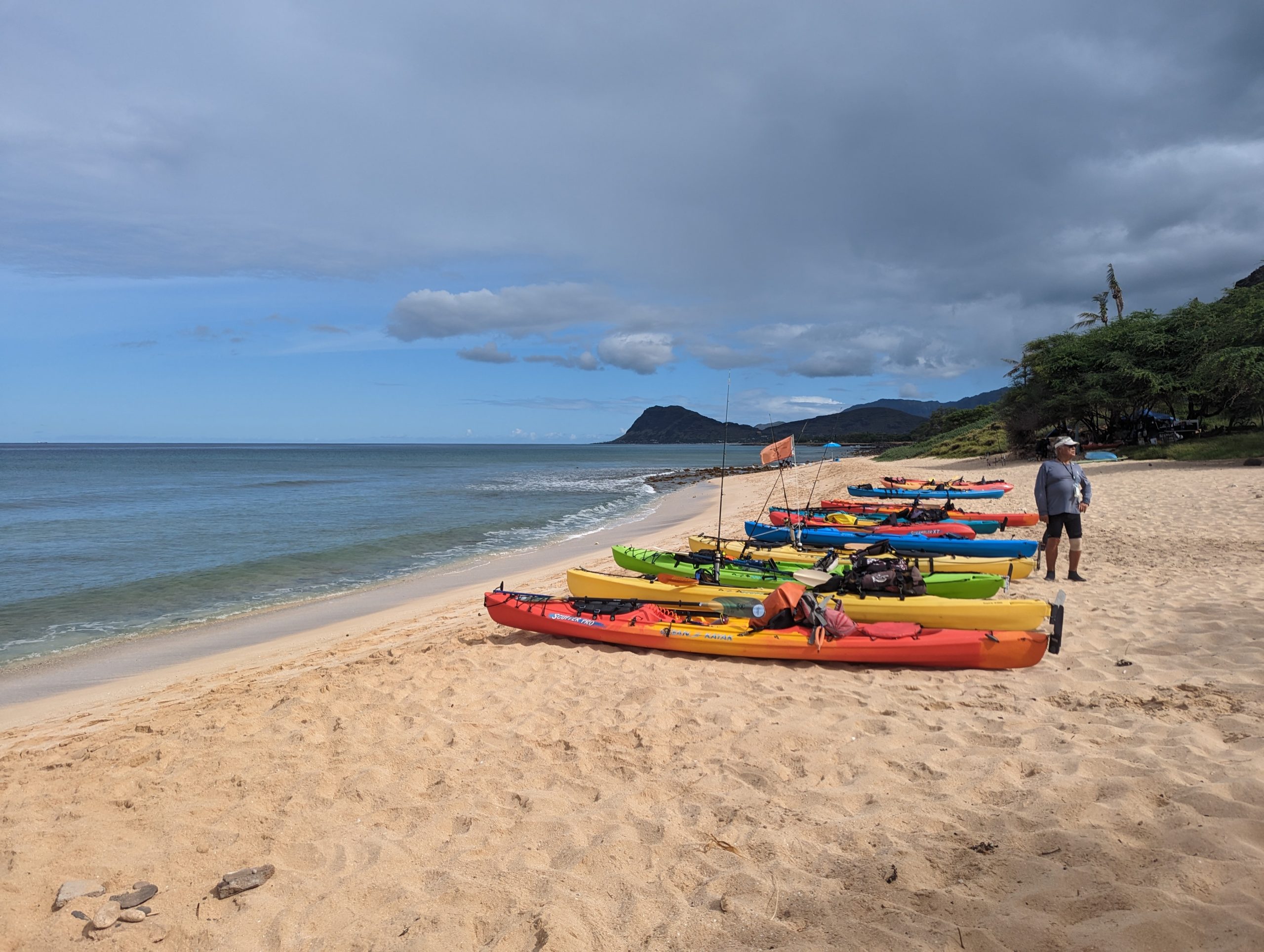 Kayaks on the beach looking at Maili Point