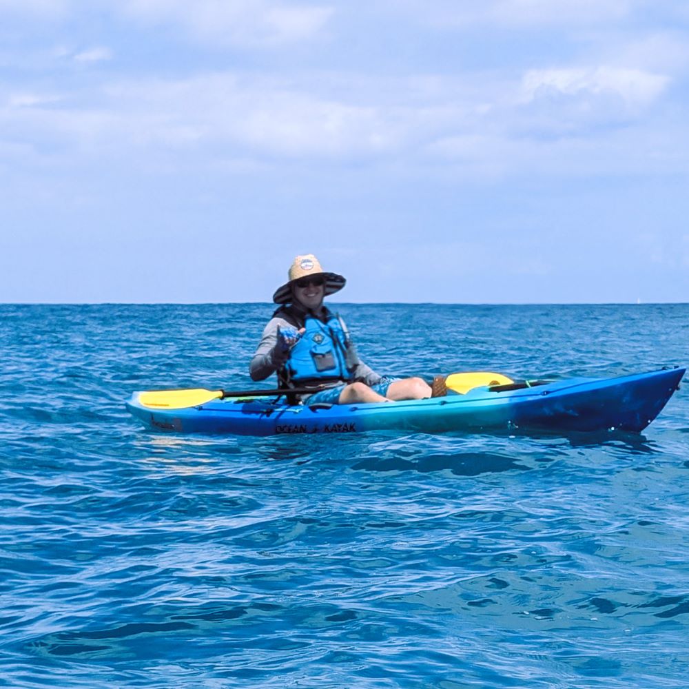 Ben flashes a shaka on the water