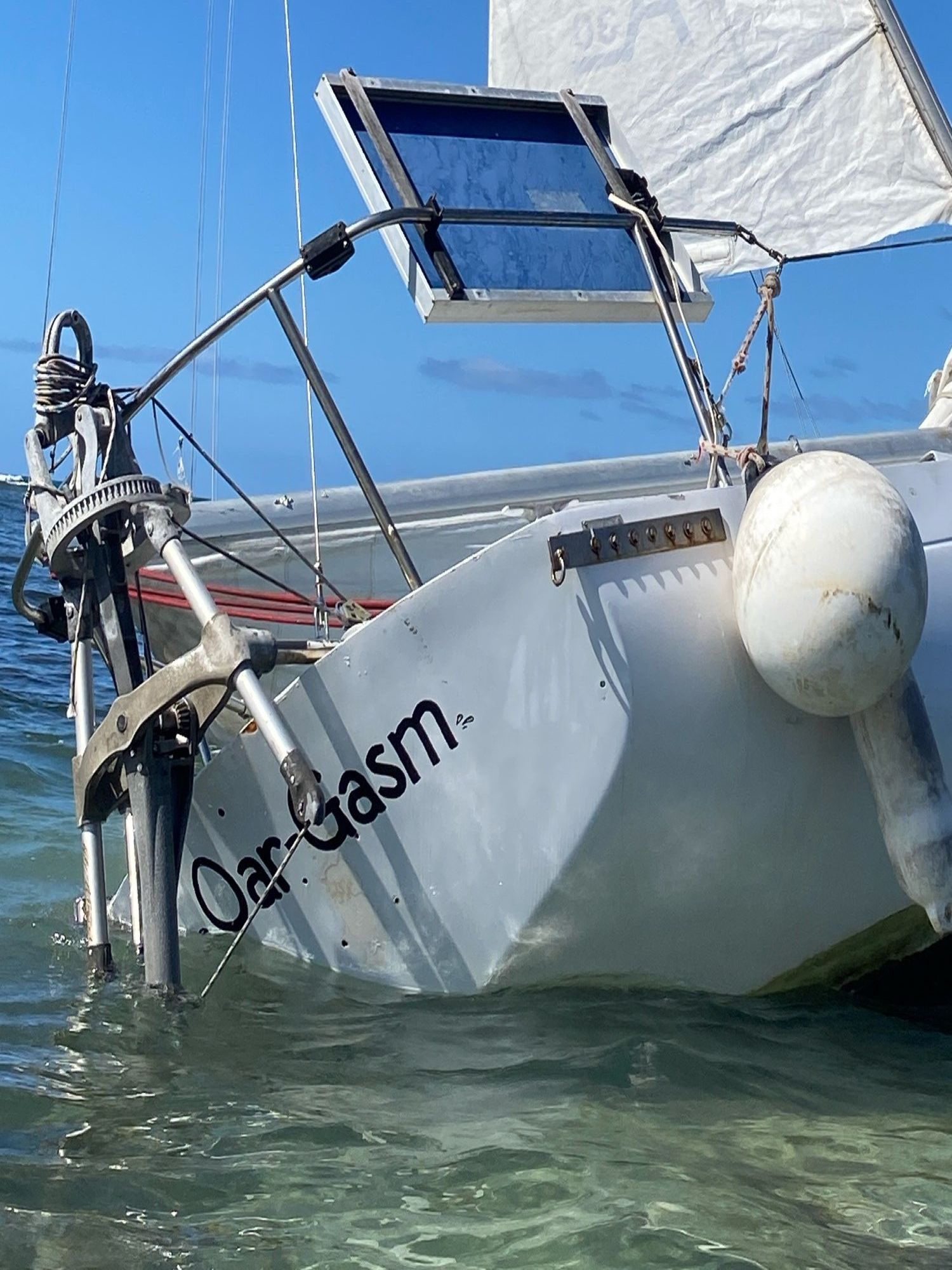 View of the stern of the grounded sailboat showing it's name "Oar-Gasm"